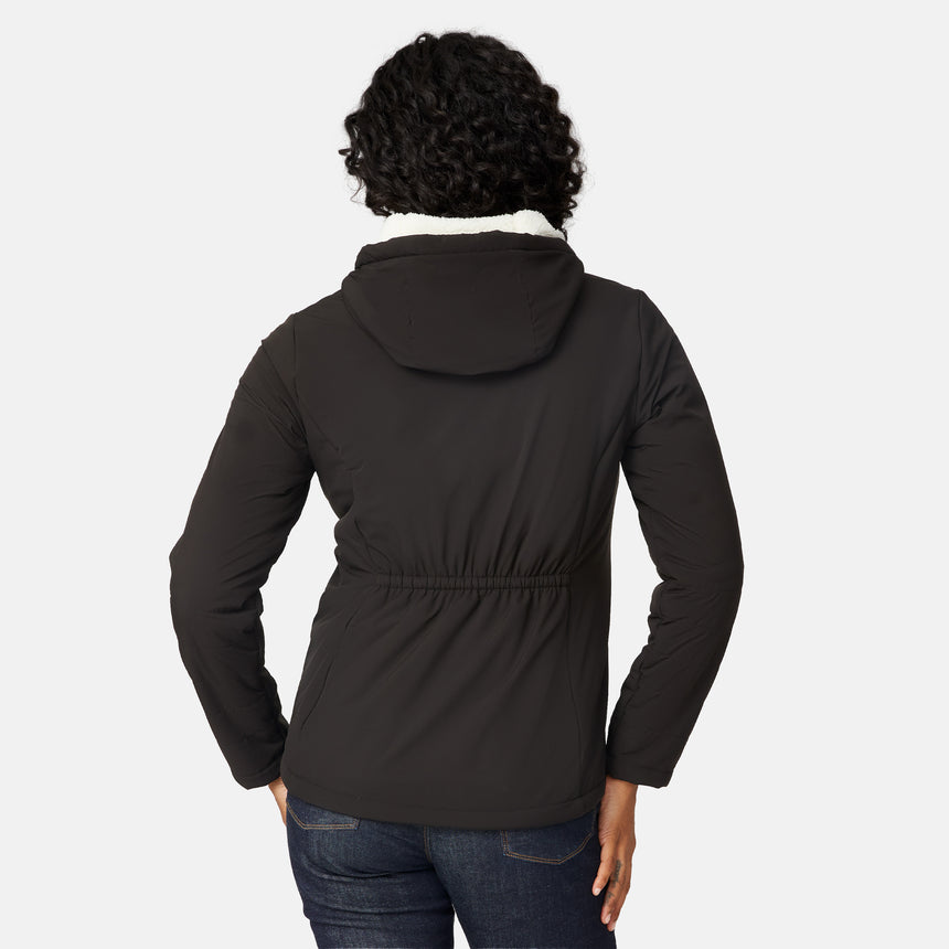 [Angelique is 5'10" wearing size S.] Women’s Free Country black hooded jacket with zip-up closure, white sherpa lining visible at the collar, and metallic drawstring tips. Features zippered side pockets and is styled with blue jeans for a clean, versatile winter look.