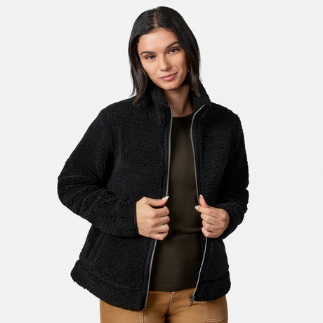 Rear view of woman in black faux shearling jacket with plush textured fabric
