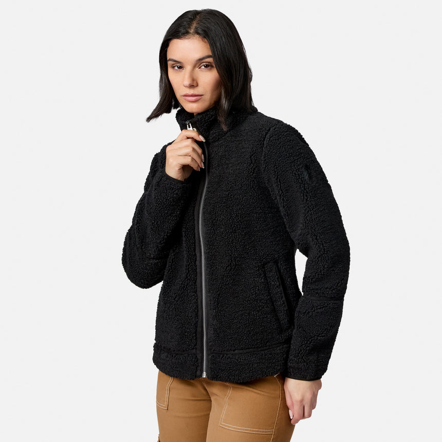 Model wearing black faux shearling jacket with front zip closure