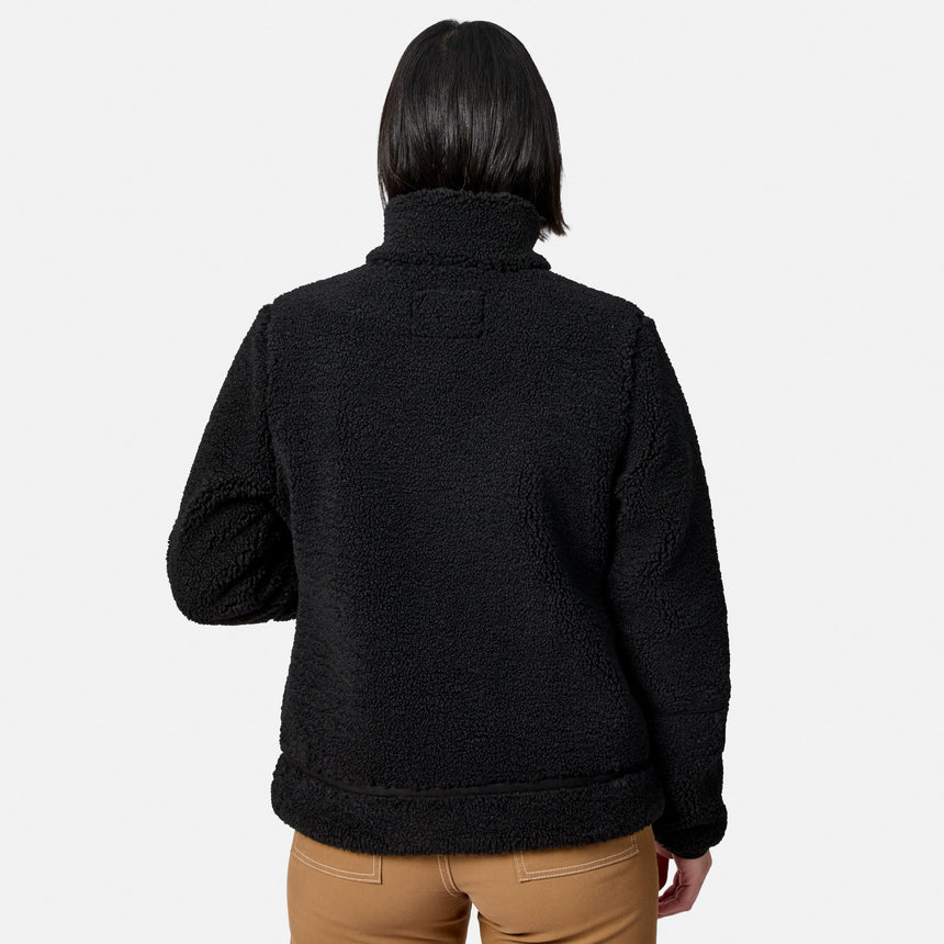 Back view of woman in black faux shearling jacket detailing fleece texture and hem