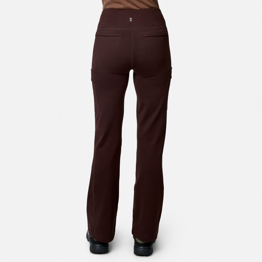 Model wearing Free Country Women’s Trail 2 Town Flare Pants in dark brown, featuring two back pockets and a slight flare, paired with black shoes. Shown from the back against a plain white background.
