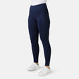 A person wears Free Country Women's Trail 2 Town Legging, featuring a high-rise waistband and side pockets, paired with white sneakers, standing against a plain white background.
