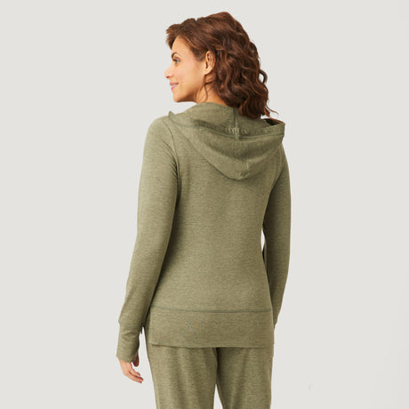 A woman with curly brown hair is shown from the back, wearing the Clearance Women's Free 2 Go Out Zip Hoodie in olive green with matching four-way stretch shorts, set against a plain white background.