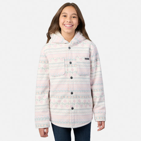 A smiling girl wears a cream-colored Girls’ Chill Out Fleece Shirt Jacket featuring a pink and green plaid print, sherpa lining, and a hood.