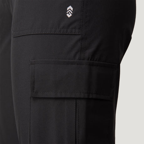 Close-up of Free Country Women’s Get Out There Fleece Lined Jogger highlighting a large cargo pocket, small white logo above it, and fabric texture with visible stitching. These fleece-lined joggers offer water resistance, durability, and versatility.
