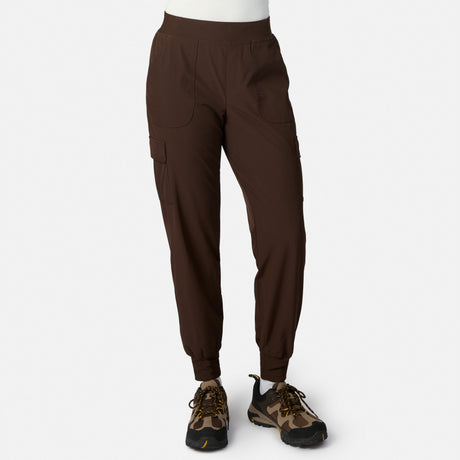 Model wearing dark brown Women’s Get Out There Fleece Lined Jogger by Free Country with brown camo sneakers, standing against a white background. Only the lower half is visible, showcasing the comfy, stylish water-resistant joggers.
