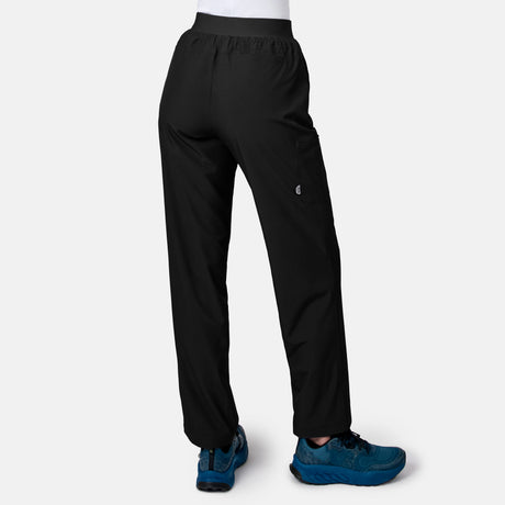[Model is wearing size S.] Black athletic pants shown from the back on a model, featuring a small white The North Face logo on the left thigh and blue trail running shoes, set against a light gray background.