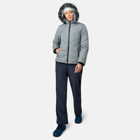 Person wearing a gray hooded puffer jacket with faux fur trim, Free Country Women’s Get Out There Fleece Lined Pants, and blue shoes, standing and facing forward against a plain white background.