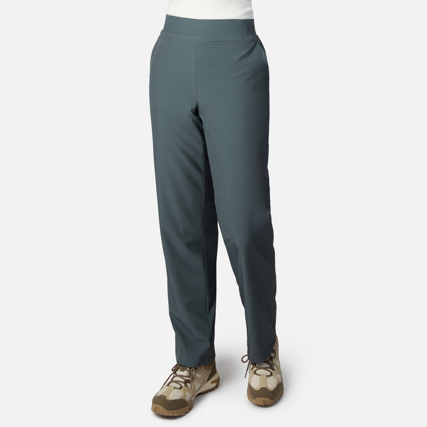 A person models Free Country Women’s Get Out There Fleece Lined Pants in Loden, paired with beige hiking shoes, against a white background. Only the lower half of their body is shown.