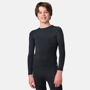 Child wearing a black long-sleeve base layer shirt and black base layer pants on a white background