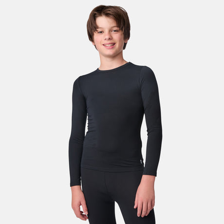 Child wearing a black long-sleeve base layer shirt and black base layer pants on a white background