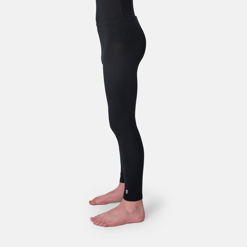 Child wearing a black long-sleeve base layer shirt and black base layer pants on a white background