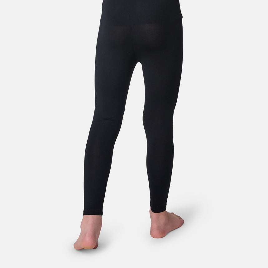 Black leggings worn by a child on a white background