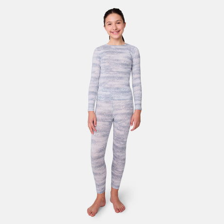 Child wearing a gray and white striped long-sleeve base layer top and leggings on a light gray background