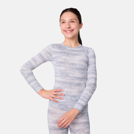 Child wearing a gray and white striped long-sleeve base layer top and leggings on a light gray background