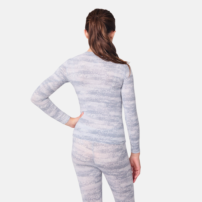 Child wearing a gray marbled long-sleeve top and pants on a white background