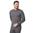 A man stands wearing the Free Country Men's Force Grid Fleece Base Layer Top in gray, paired with matching bottoms, looking slightly to his right with a neutral expression.