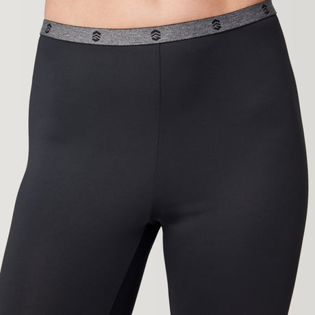 Women’s Microtech® Heat Cocarber® Coffee Base Layer Bottoms by Free Country, shown here in black with a gray marled elastic waistband featuring repeating black logo icons. Crafted from breathable, four-way stretch fabric and displayed on a model from waist to mid-thigh. Comes as a 2-pack.