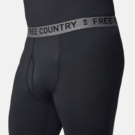 Close-up of a person wearing Free Country Men’s Microtech® Heat Cocarber® Coffee Base Layer Bottoms, featuring black athletic leggings with a gray waistband that reads FREE COUNTRY in bold letters. Designed with four-way stretch for optimal comfort, the focus is on the waistband and upper part of these performance base layer bottoms.