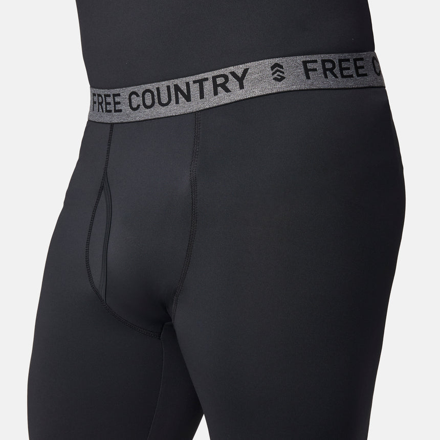 Close-up of a person wearing Free Country Men’s Microtech® Heat Cocarber® Coffee Base Layer Bottoms, featuring black athletic leggings with a gray waistband that reads FREE COUNTRY in bold letters. Designed with four-way stretch for optimal comfort, the focus is on the waistband and upper part of these performance base layer bottoms.