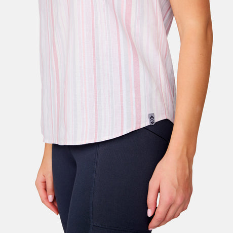 A person wearing the Free Country Women's Easy Breezy Shirt in pastel stripes and black leggings, shown from the waist down with arms relaxed at their sides.