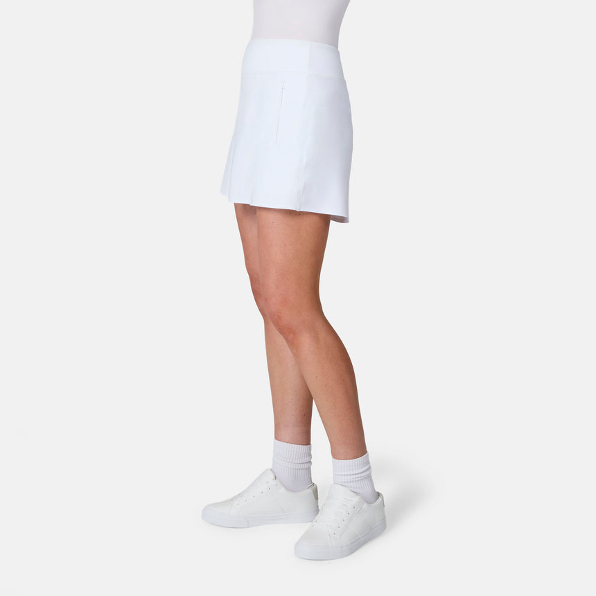 [Model is wearing size S] Person wearing a white skirt, white shirt, and white shoes on a light gray background