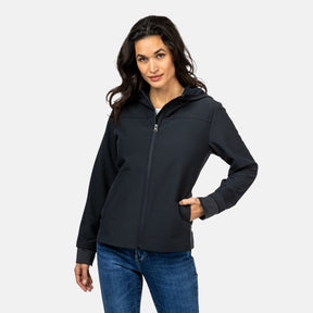 [Model is wearing a size Small.] Woman wearing Free Country Women's Venture Out Hybrid Jacket in black with a full front zipper opening, lower pockets, stretch panels, a hood, and water resistant and wind resistant stretch performance fabric, light grey background. Best women’s jacket for all weather.