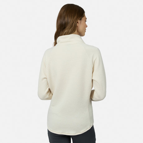 Back view of a woman wearing a cream-colored, seamless quilting Women’s UltraFill Cowl Neck Top with long sleeves.