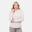 A woman smiles with one hand at her neck, modeling the Free Country Women's UltraFill Cowl Neck Top—featuring seamless quilting and light polyester fill—against a plain white background.