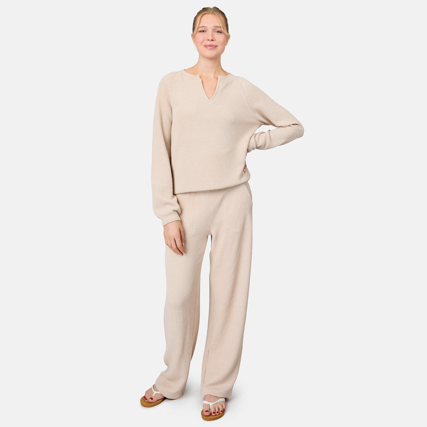 [Model is 5'10" wearing size S] Woman wearing a beige sweater and pants set on a white background