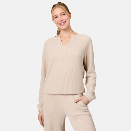 [Emily is 5'10" wearing size S] Woman wearing a beige ribbed sweater and pants on a light gray background