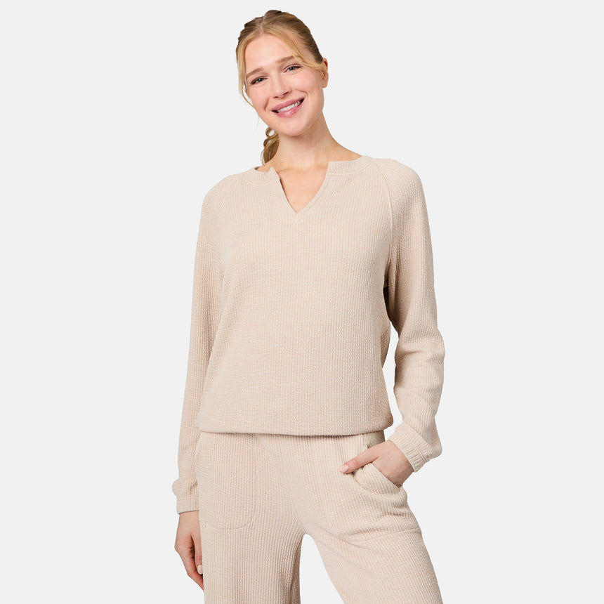 [Emily is 5'10" wearing size S] Woman wearing a beige ribbed sweater and pants on a light gray background