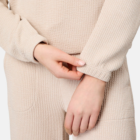 [Emily is 5'10" wearing size S] Close-up of a person wearing a beige textured sweater with hands clasped together.