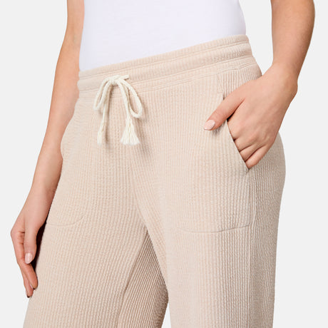 [Model is 5'10" wearing size S] Beige ribbed pants with a drawstring on a plain background