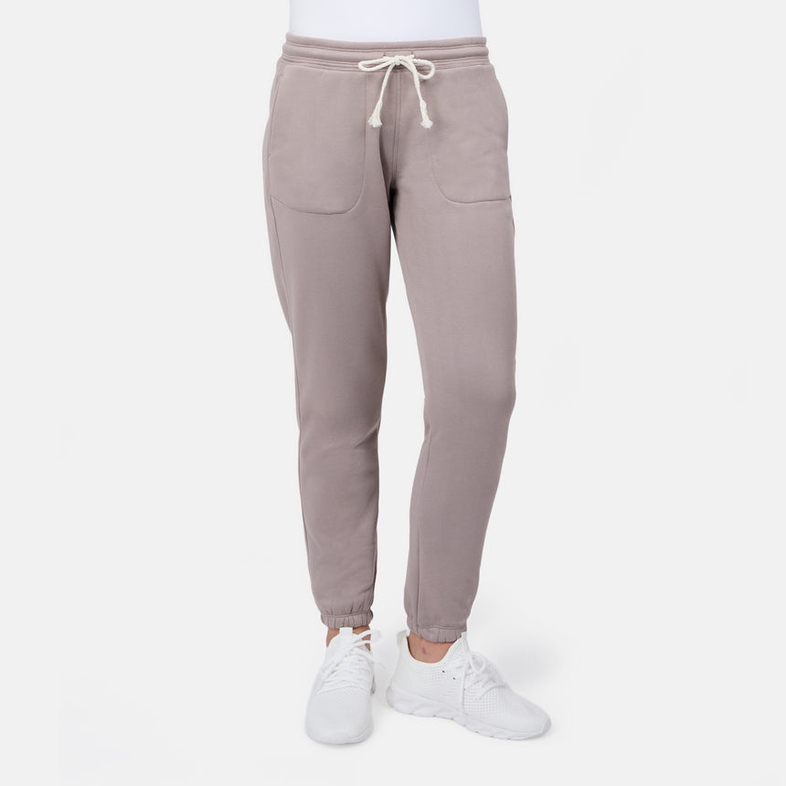 [Model is wearing size S] Beige sweatpants worn by a person on a white background