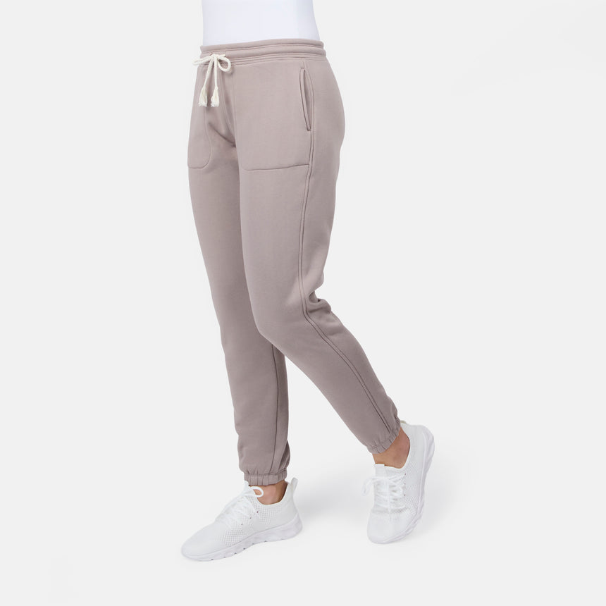 [Model is wearing size S] Taupe sweatpants worn by a person on a white background