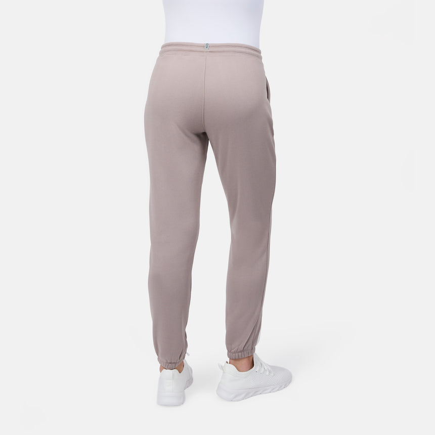 [Model is wearing size S] Beige jogger pants worn by a person on a white background