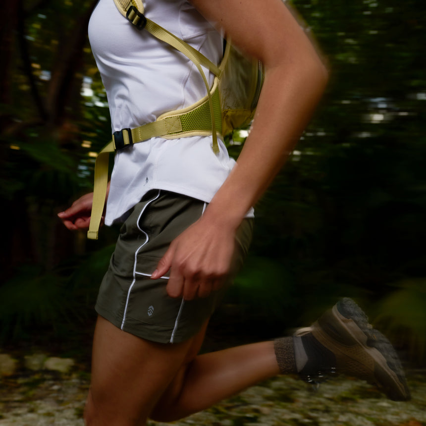 Person running outdoors with a focus on their lower body and running gear.