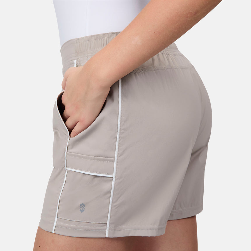 [Model is wearing size S] Beige shorts with white piping worn by a person on a light gray background