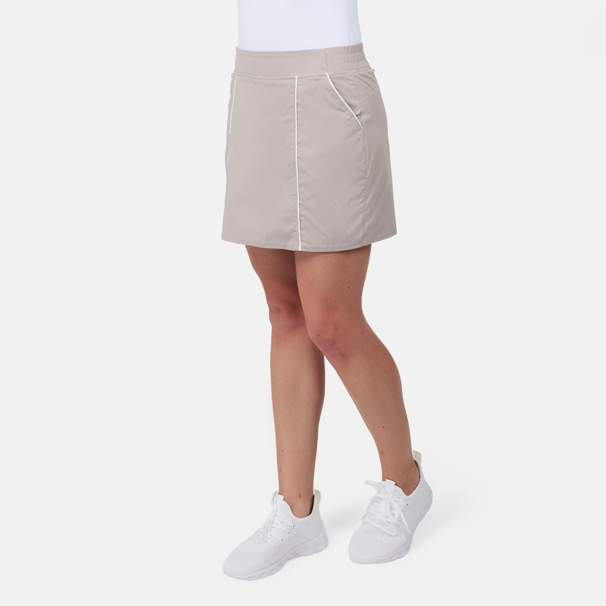 [Model is wearing size S] Person wearing a beige skirt and white sneakers on a white background