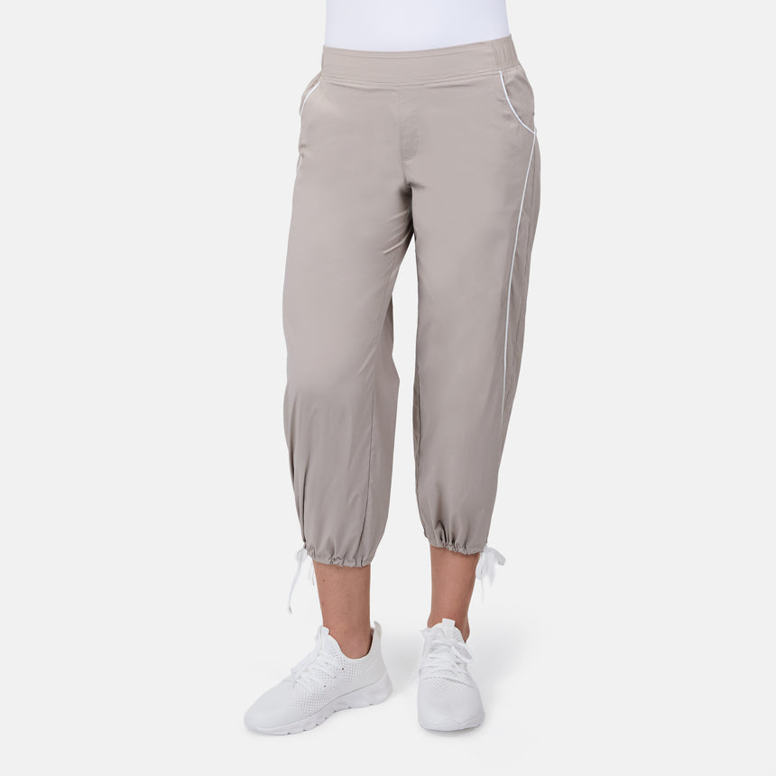 [Model is wearing size S] Person wearing beige jogger pants and white sneakers on a white background