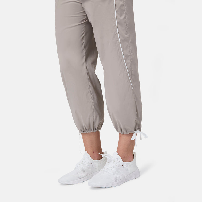 [Model is wearing size S] Light gray jogger pants with white sneakers on a white background