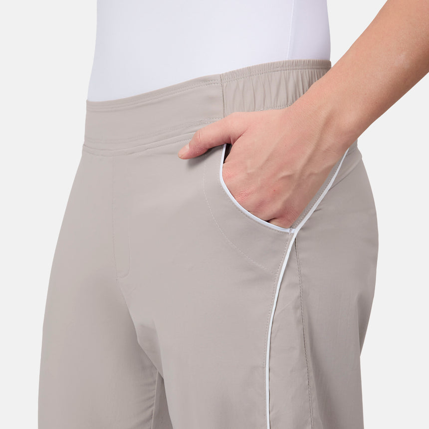 [Model is wearing size S] Beige pants with a white trim on a plain background