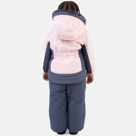 Young girl wearing the Free Country Girls' Toddler Boarder Jacket and Bib Pant Set, featuring a light pink and navy hooded jacket with Butter Pile® lining and matching navy snow pants, designed for winter play.