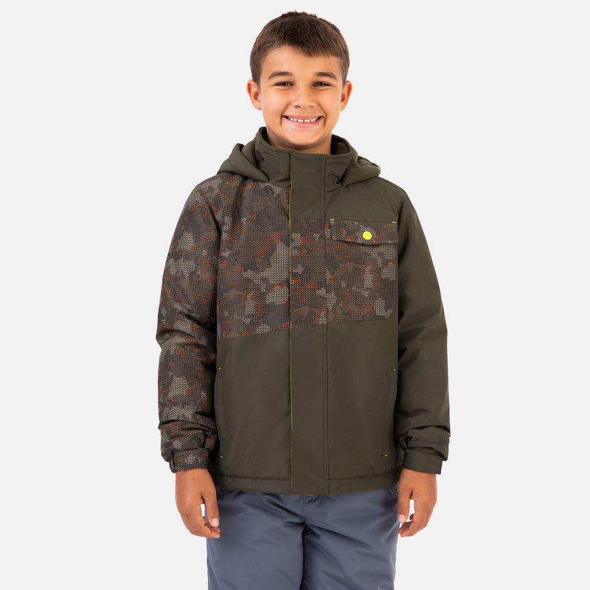 A boy smiles while wearing a Boys’ Multi Rip Stop Boarder Jacket in olive, featuring a water-resistant finish and a camo-patterned chest panel and sleeve.