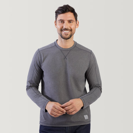 Man wearing a gray long-sleeve shirt against a light gray background