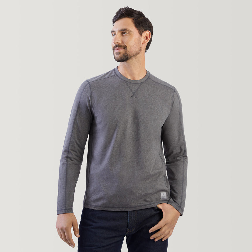 Man wearing a gray long-sleeve shirt against a plain background