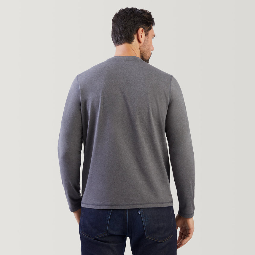 Man wearing a gray long-sleeve shirt on a light gray background