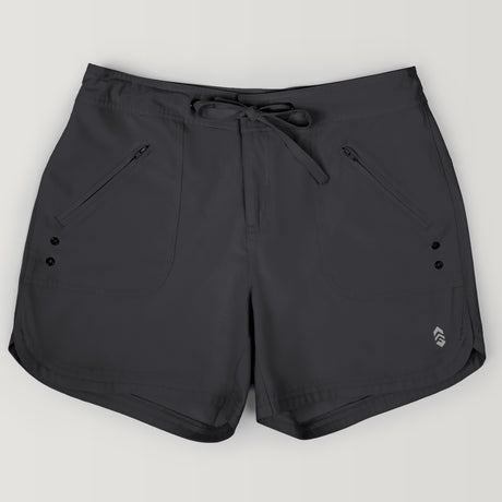 The Free Country Women's 5" Bermuda Board Short in dark gray features a drawstring waistband, zippered front pockets, a small logo near the left hem, four-way stretch fabric for comfort, and quick-drying material.