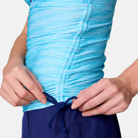 Close-up of a person wearing the Women's Textured Stripe Double Strap Tankini Top by Clearance, featuring quick-dry fabric in light blue. Only the torso and hands are visible against a plain background as they adjust the top.